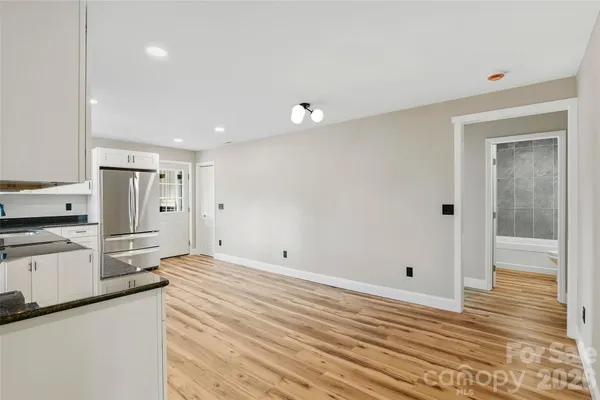 a view of a kitchen with wooden floor