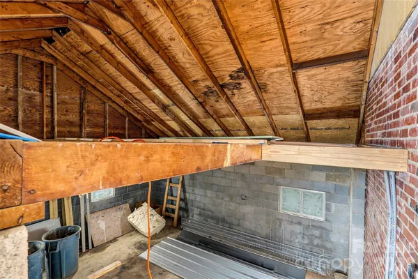 an empty room with wooden floor and a ceiling fan