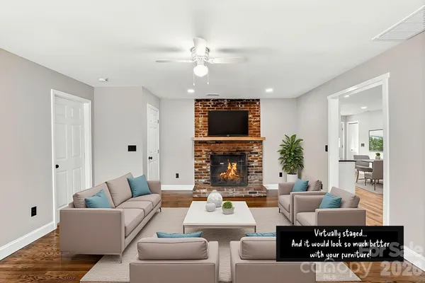 a living room with fireplace furniture and a flat screen tv