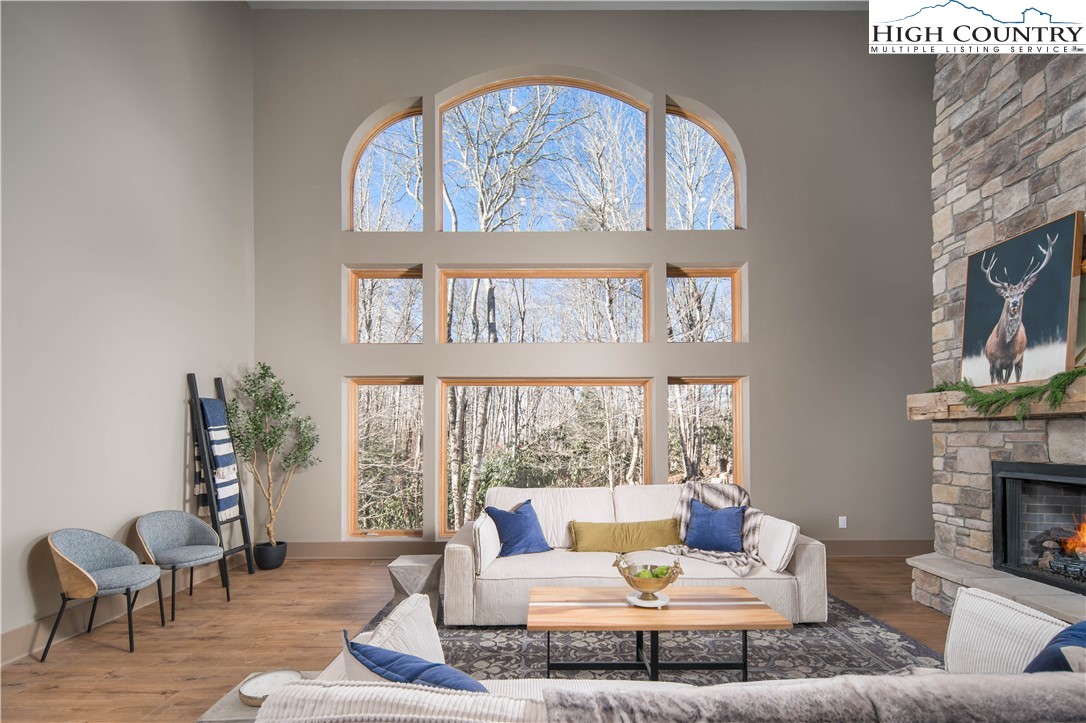216 Greenbriar Road Beech Mountain, NC 28604 - Photo 11 of 50 a living room with furniture a fireplace and a large window
