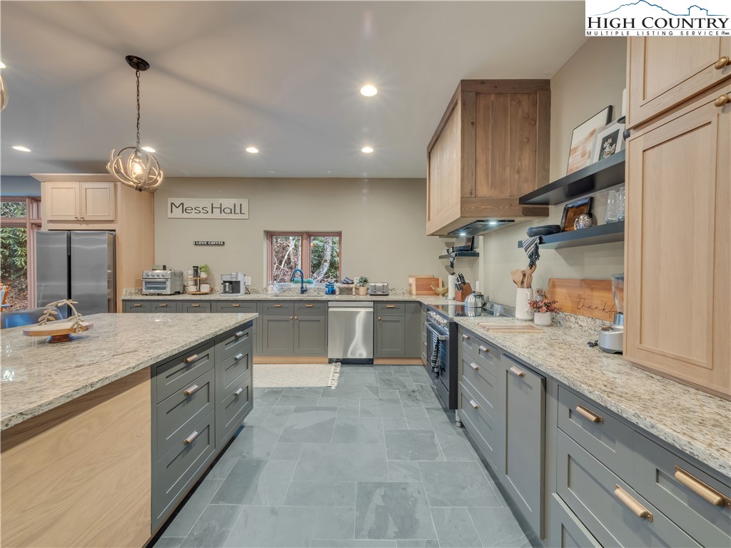 216 Greenbriar Road Beech Mountain, NC 28604 - Photo 13 of 50 a large kitchen with stainless steel appliances kitchen island granite countertop a sink counter space cabinets and a large window