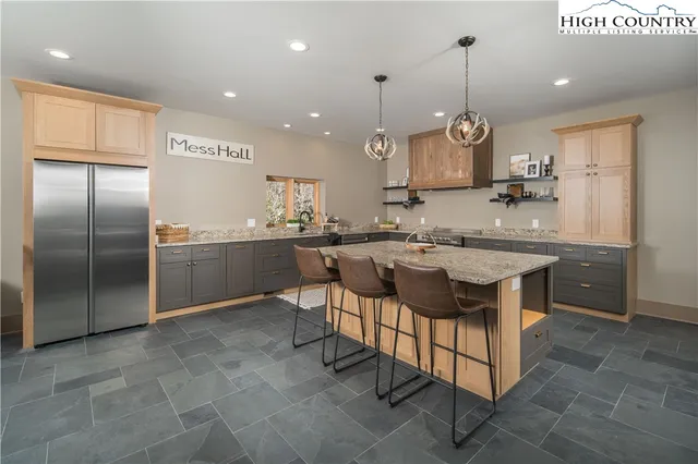 a kitchen with a table chairs refrigerator and microwave
