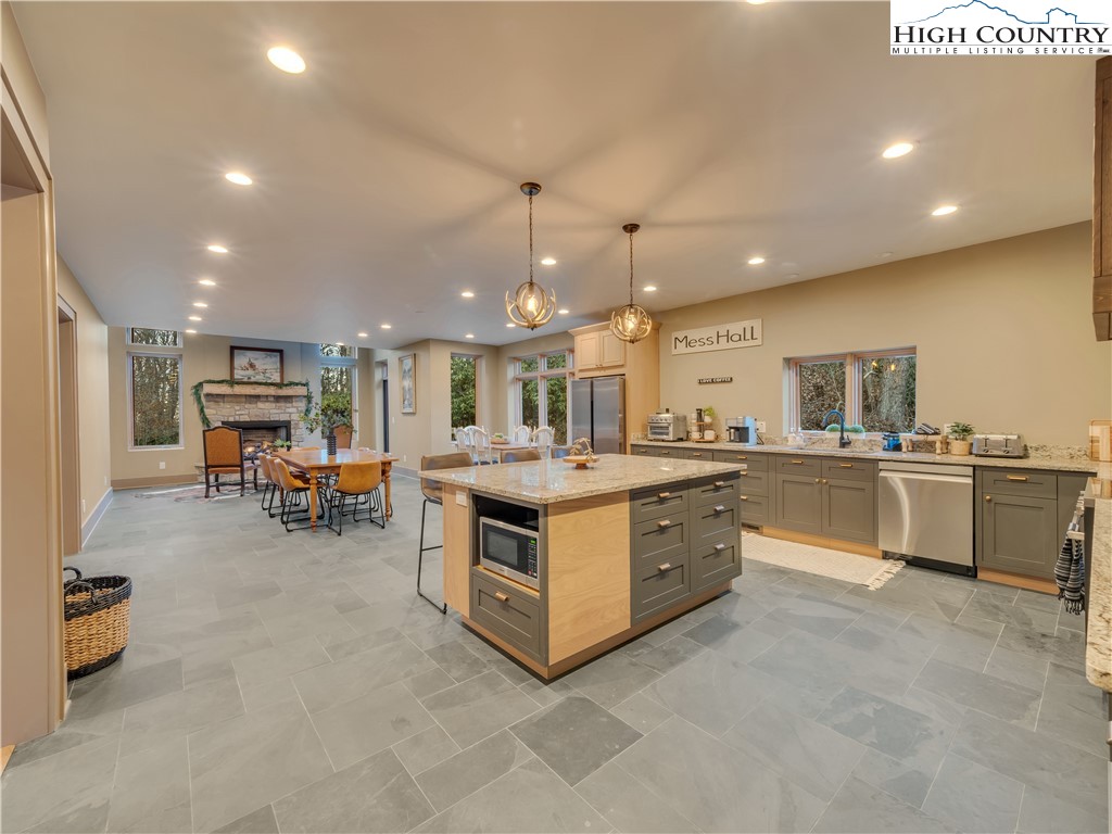 216 Greenbriar Road Beech Mountain, NC 28604 - Photo 16 of 50 a large white kitchen with a large counter top and stainless steel appliances
