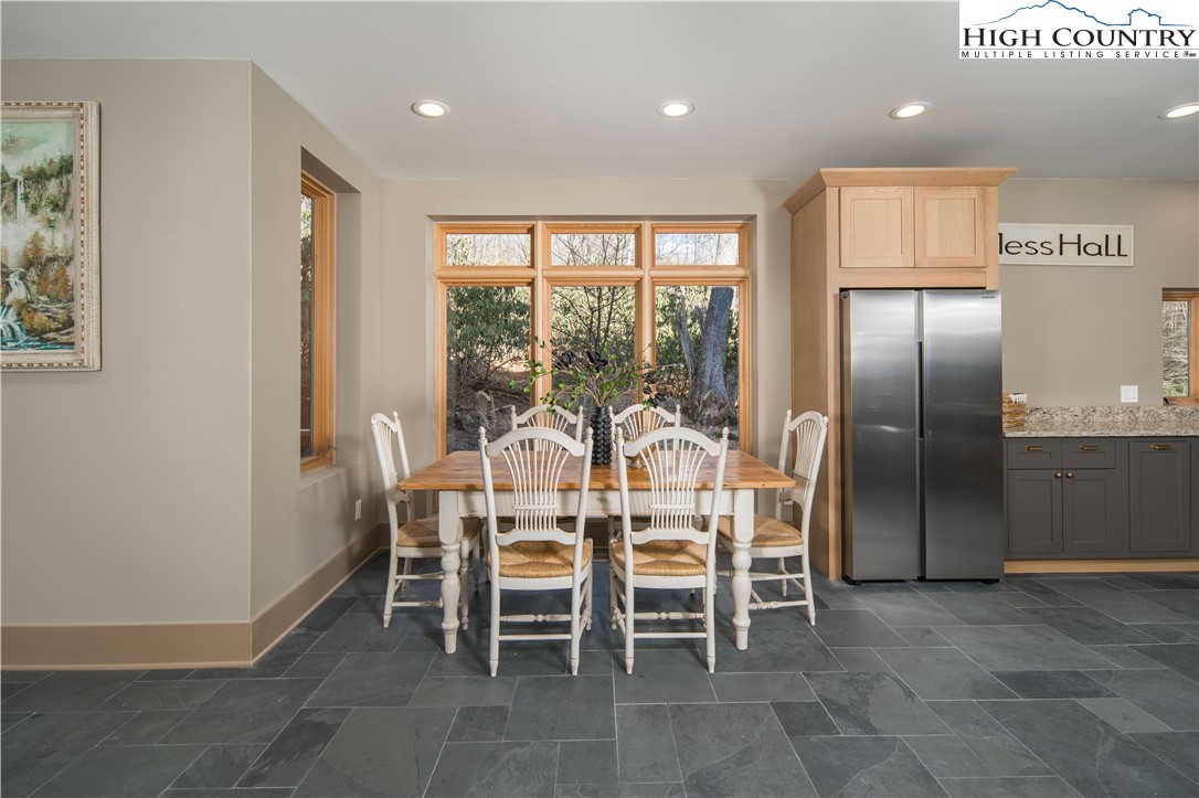 216 Greenbriar Road Beech Mountain, NC 28604 - Photo 17 of 50 a dining room with furniture and a floor to ceiling window