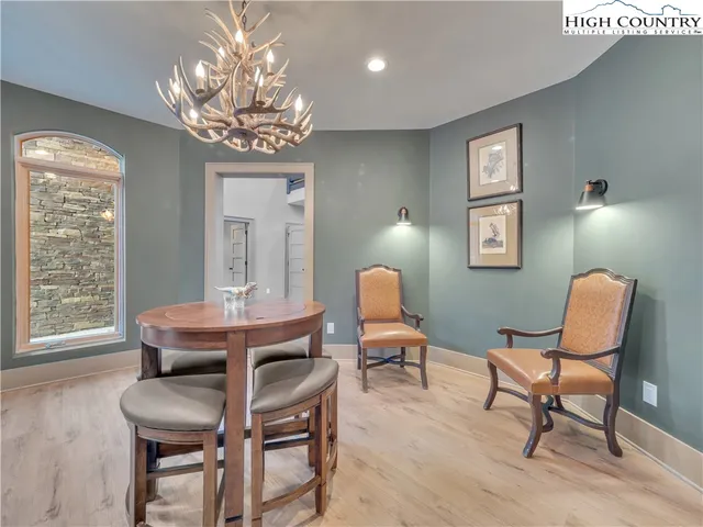 a view of a dining room with furniture and chandelier