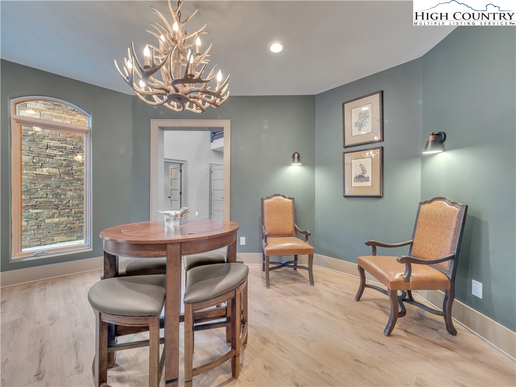 216 Greenbriar Road Beech Mountain, NC 28604 - Photo 18 of 50 a view of a dining room with furniture and chandelier