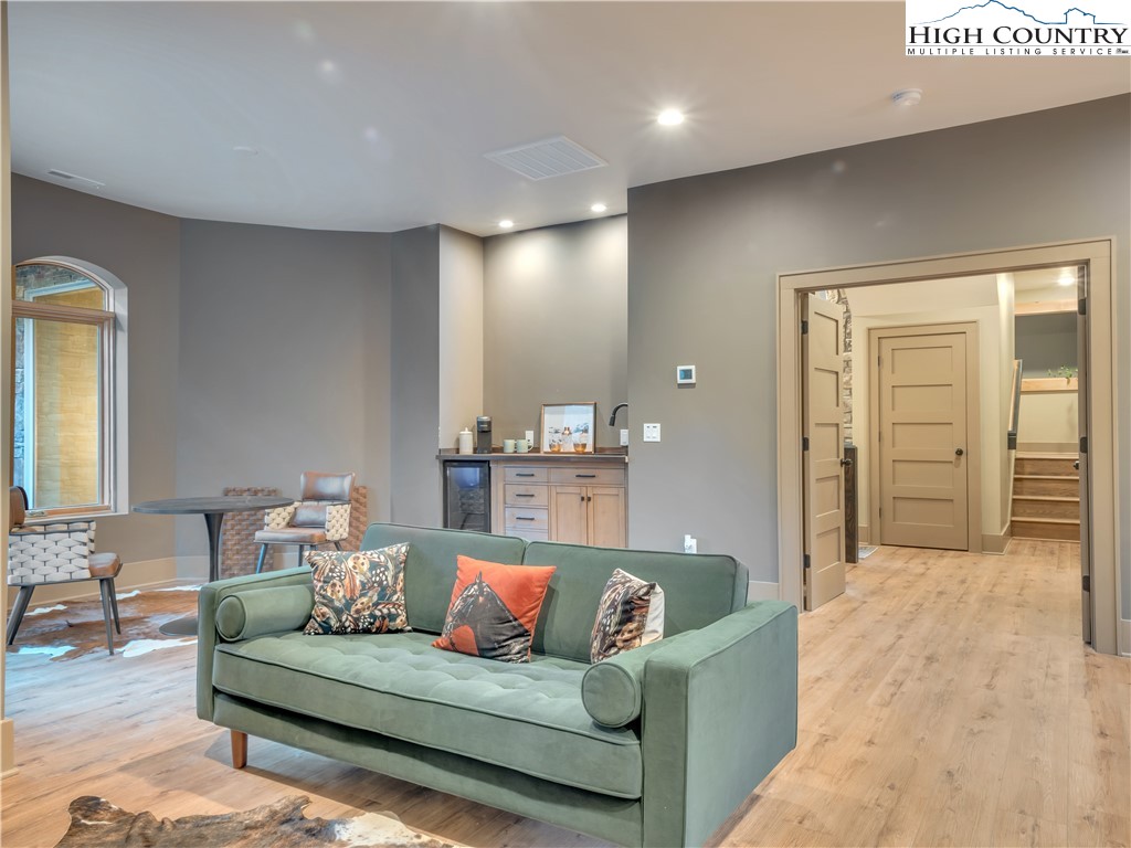 216 Greenbriar Road Beech Mountain, NC 28604 - Photo 22 of 50 a living room with furniture and a wooden floor