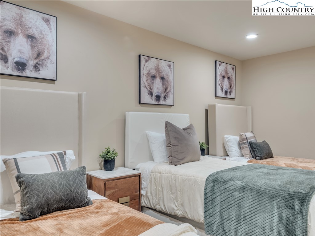 216 Greenbriar Road Beech Mountain, NC 28604 - Photo 23 of 50 a bedroom with a bed and glass wall paintings