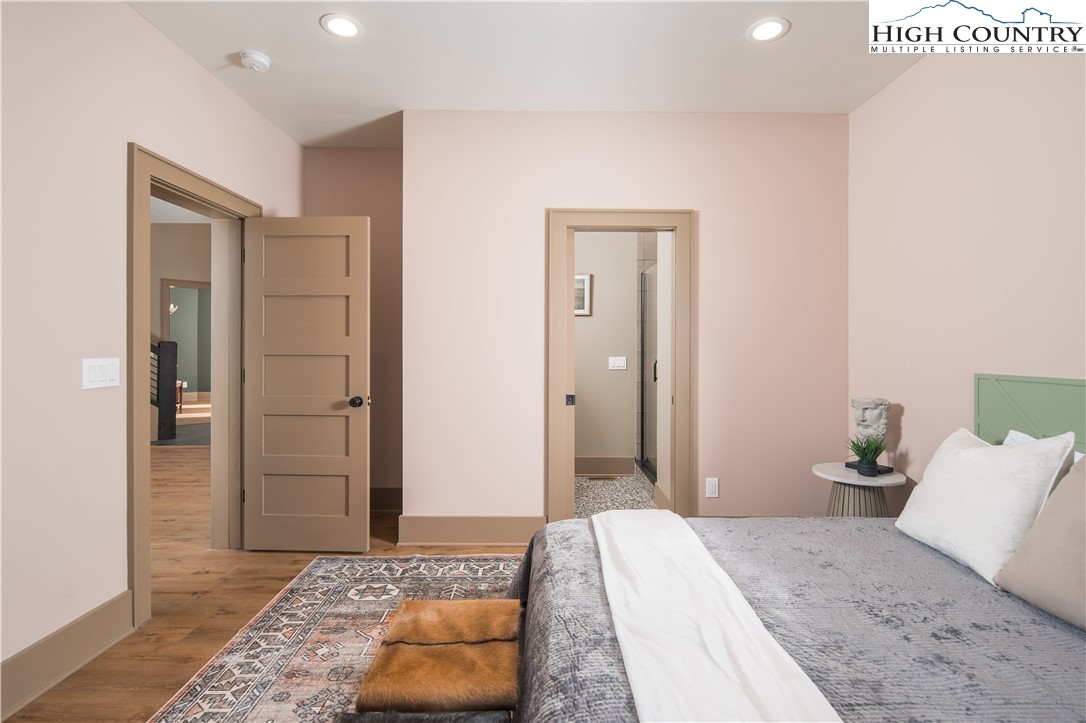 216 Greenbriar Road Beech Mountain, NC 28604 - Photo 25 of 50 a bedroom with a bed and a rug