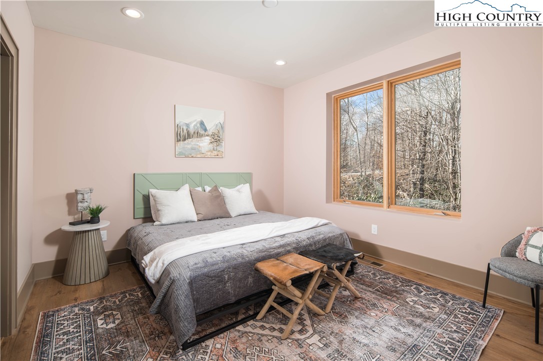 216 Greenbriar Road Beech Mountain, NC 28604 - Photo 26 of 50 a bedroom with a bed and wooden floor