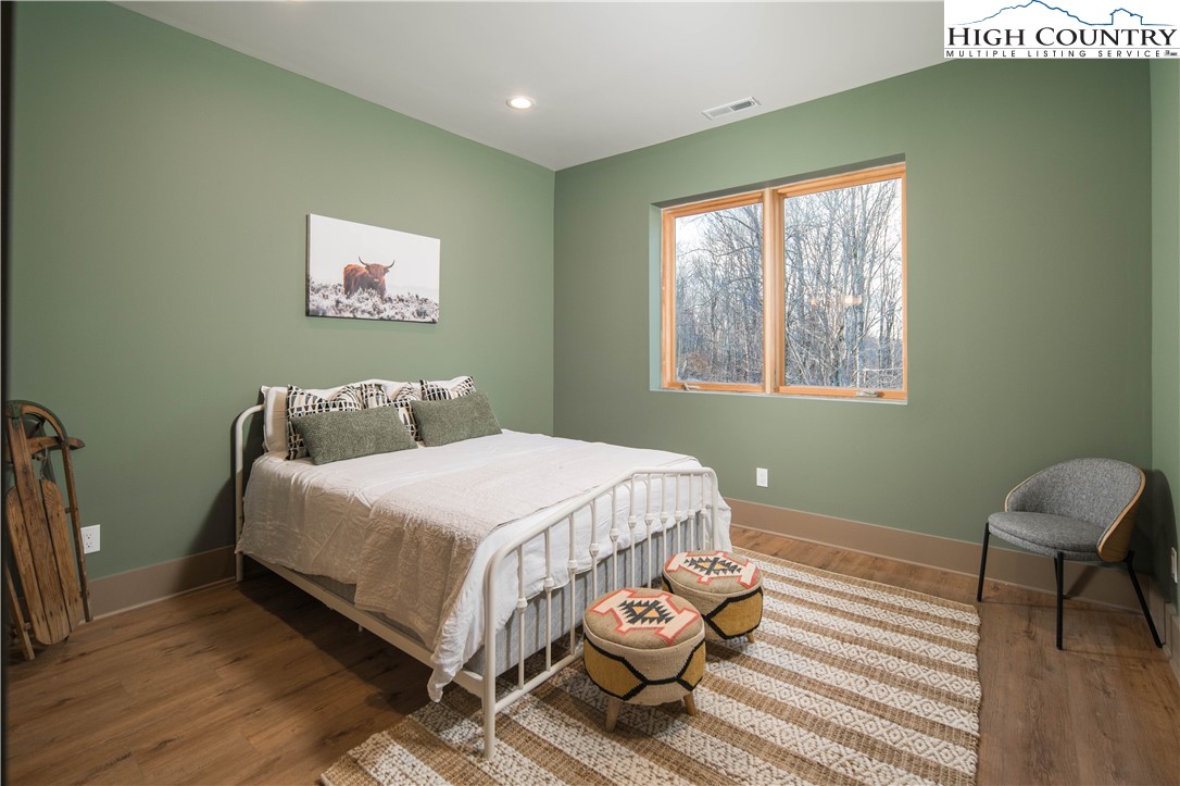 216 Greenbriar Road Beech Mountain, NC 28604 - Photo 27 of 50 a bedroom with a bed and a window