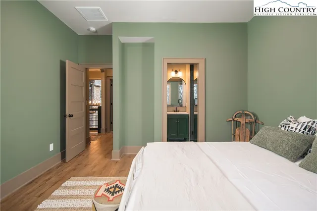 a bedroom with a bed and a mirror