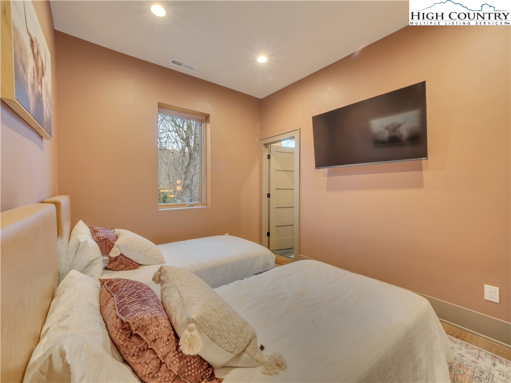 216 Greenbriar Road Beech Mountain, NC 28604 - Photo 34 of 50 a bedroom with a large bed and a flat screen tv