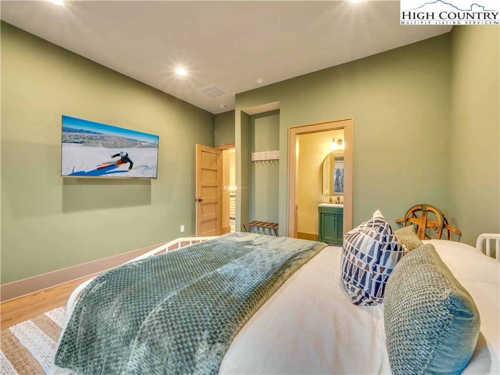 216 Greenbriar Road Beech Mountain, NC 28604 - Photo 37 of 50 a bedroom with a bed and a painting on the wall