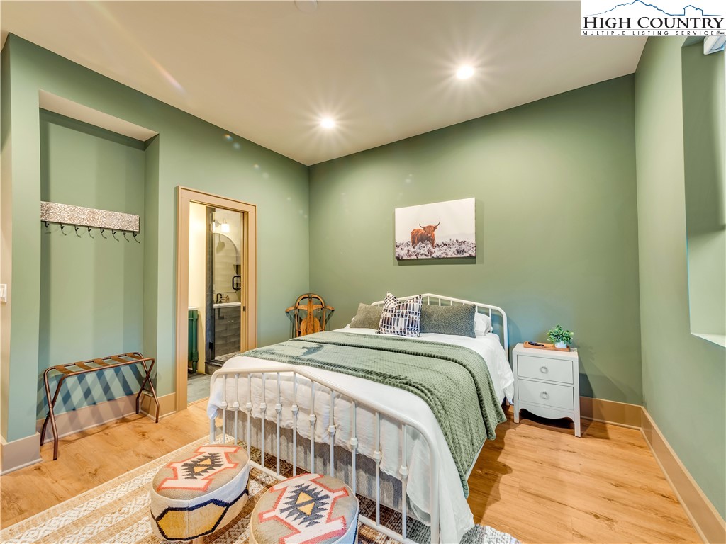 216 Greenbriar Road Beech Mountain, NC 28604 - Photo 38 of 50 a bedroom with a bed and wooden floor