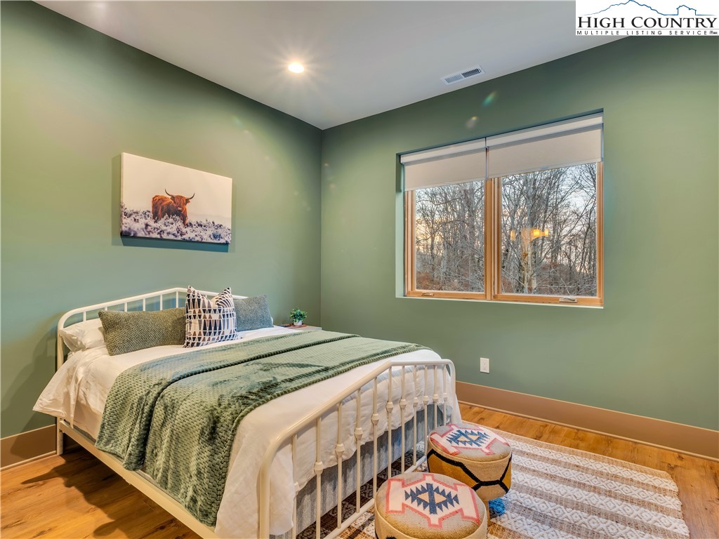 216 Greenbriar Road Beech Mountain, NC 28604 - Photo 39 of 50 a bedroom with a bed and a painting on the wall