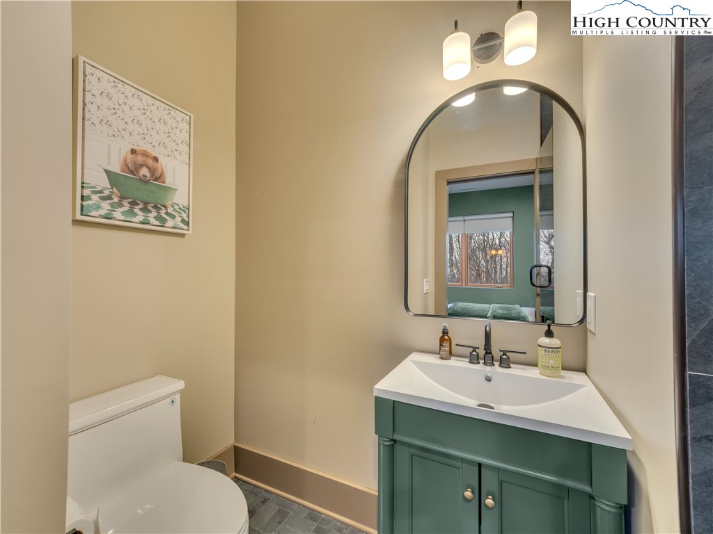 216 Greenbriar Road Beech Mountain, NC 28604 - Photo 41 of 50 a bathroom with a toilet sink and mirror