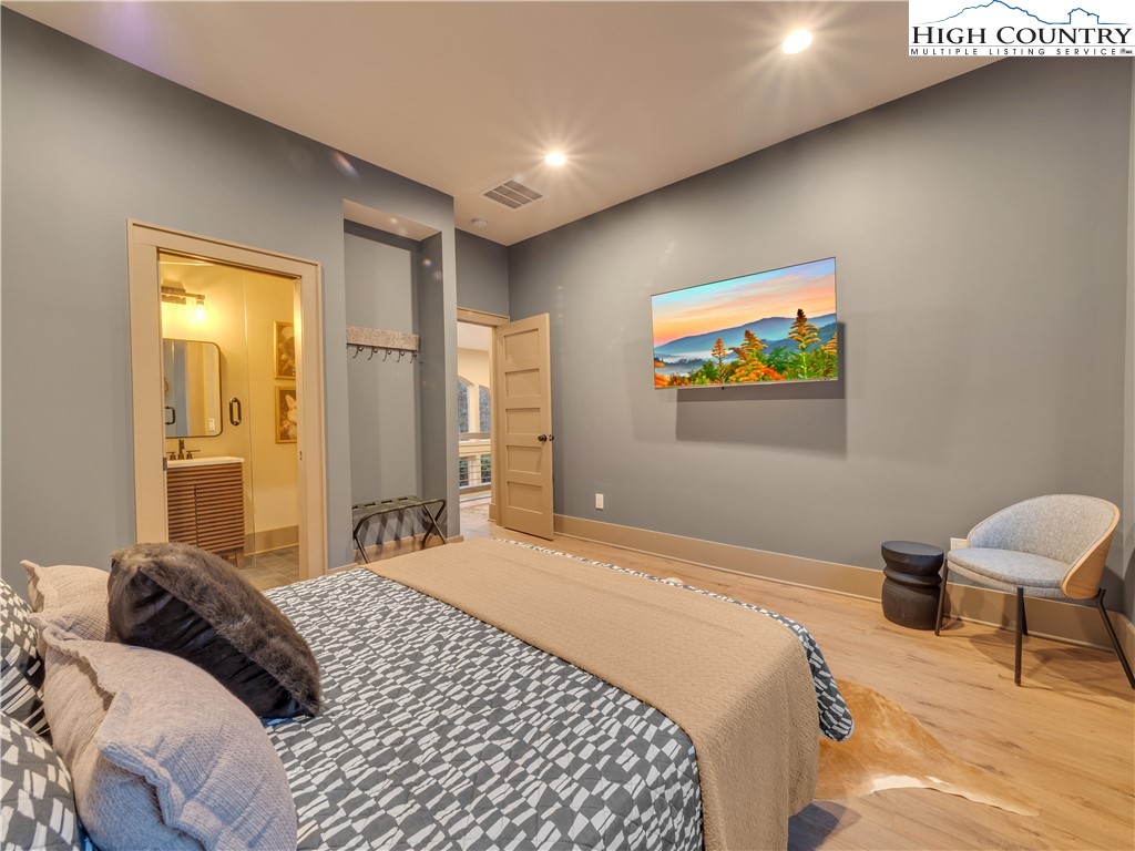 216 Greenbriar Road Beech Mountain, NC 28604 - Photo 44 of 50 a bedroom with a bed and a painting on the wall