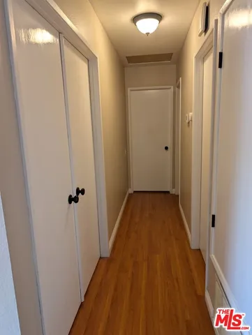a view of a bathroom with a sink and wooden floor