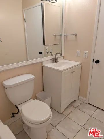 a bathroom with a sink mirror vanity and toilet