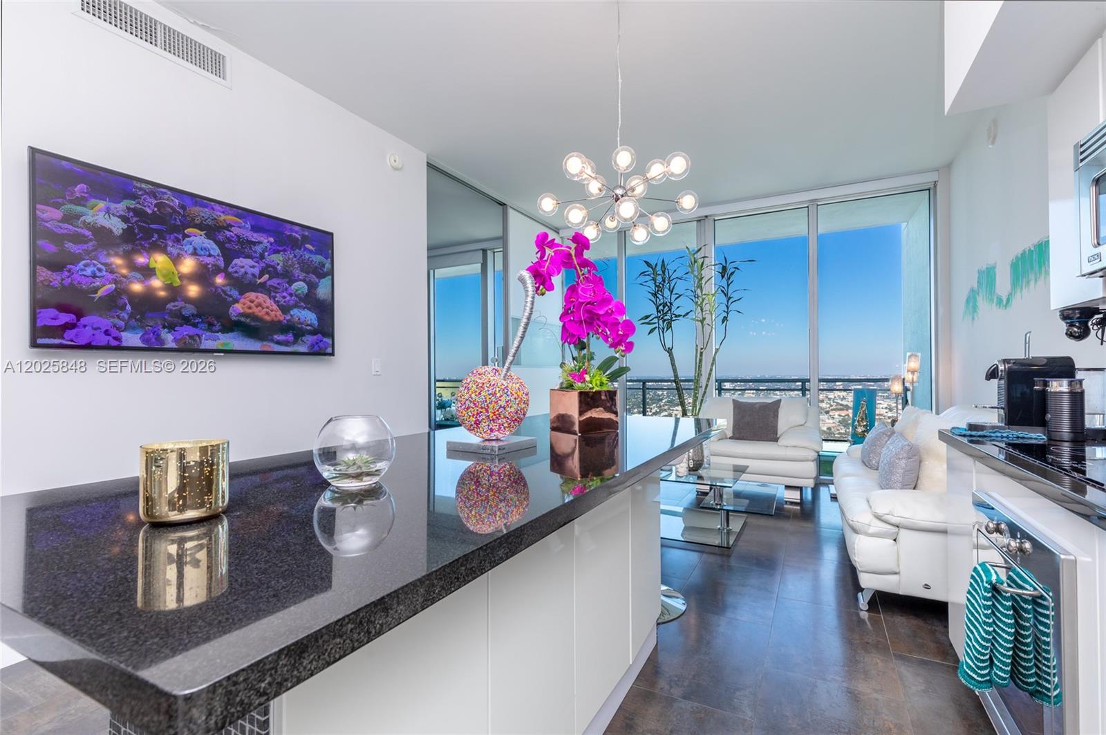 92 Southwest 3rd Street, Unit 5108 Miami, FL 33130 - Photo 2 of 33 a living room with furniture and a chandelier