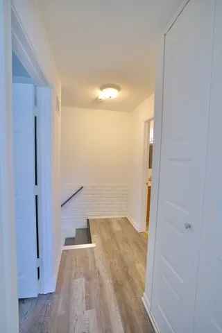 a view of a room with wooden floor