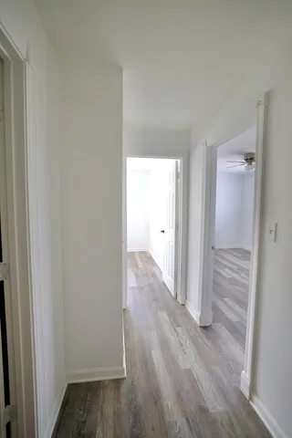 a bathroom with a granite countertop toilet sink mirror and vanity