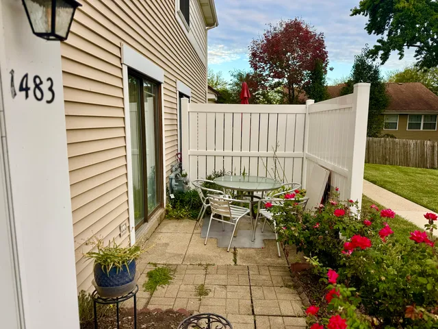 a view of a chairs and table in the backyard