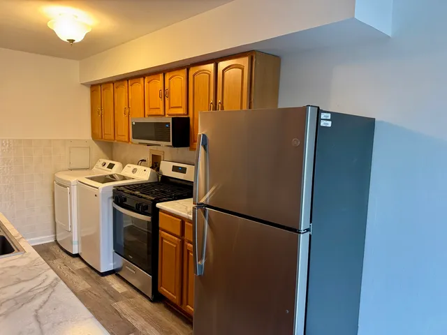 a kitchen with a refrigerator and a stove