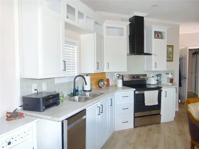 a kitchen with white cabinets and appliances