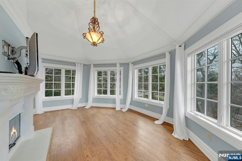 125 Jackson Drive Cresskill, NJ 07626 - Photo 21 of 46 a view of an empty room with a window and wooden floor