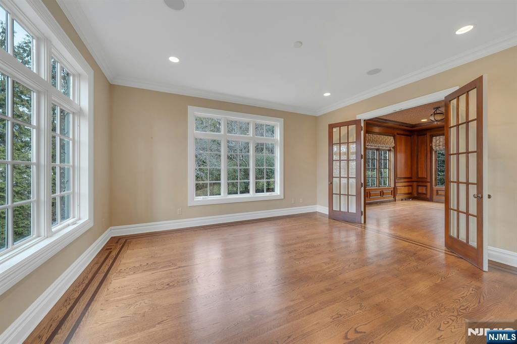 125 Jackson Drive Cresskill, NJ 07626 - Photo 8 of 46 an empty room with wooden floor and windows