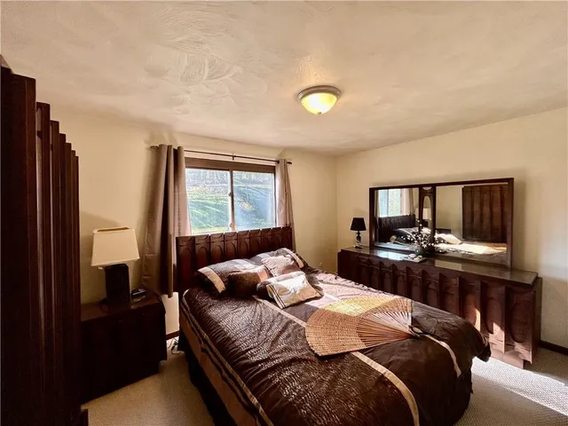 a bedroom with a bed and a television