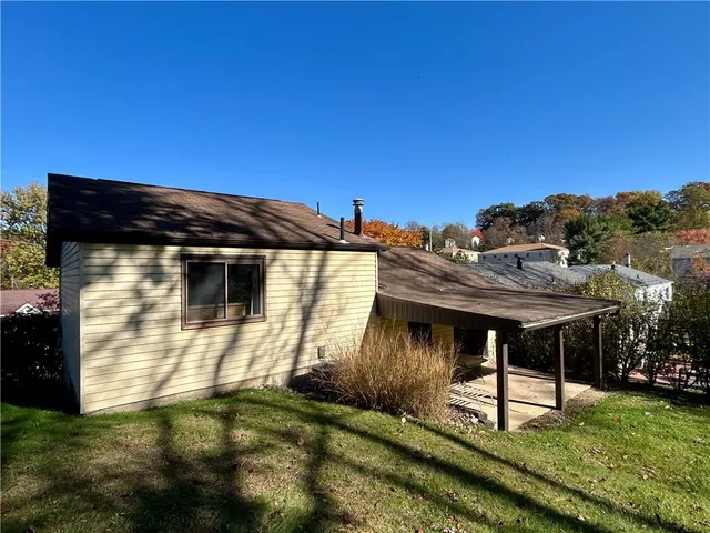 a backyard of a house with table and chairs