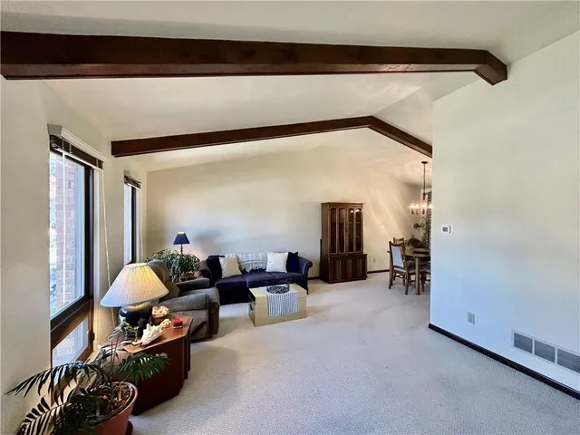a living room with furniture and a lamp