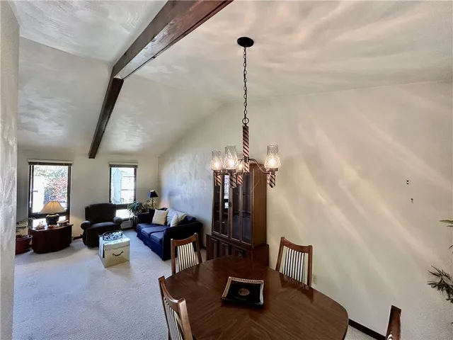 a view of a livingroom with furniture and a window
