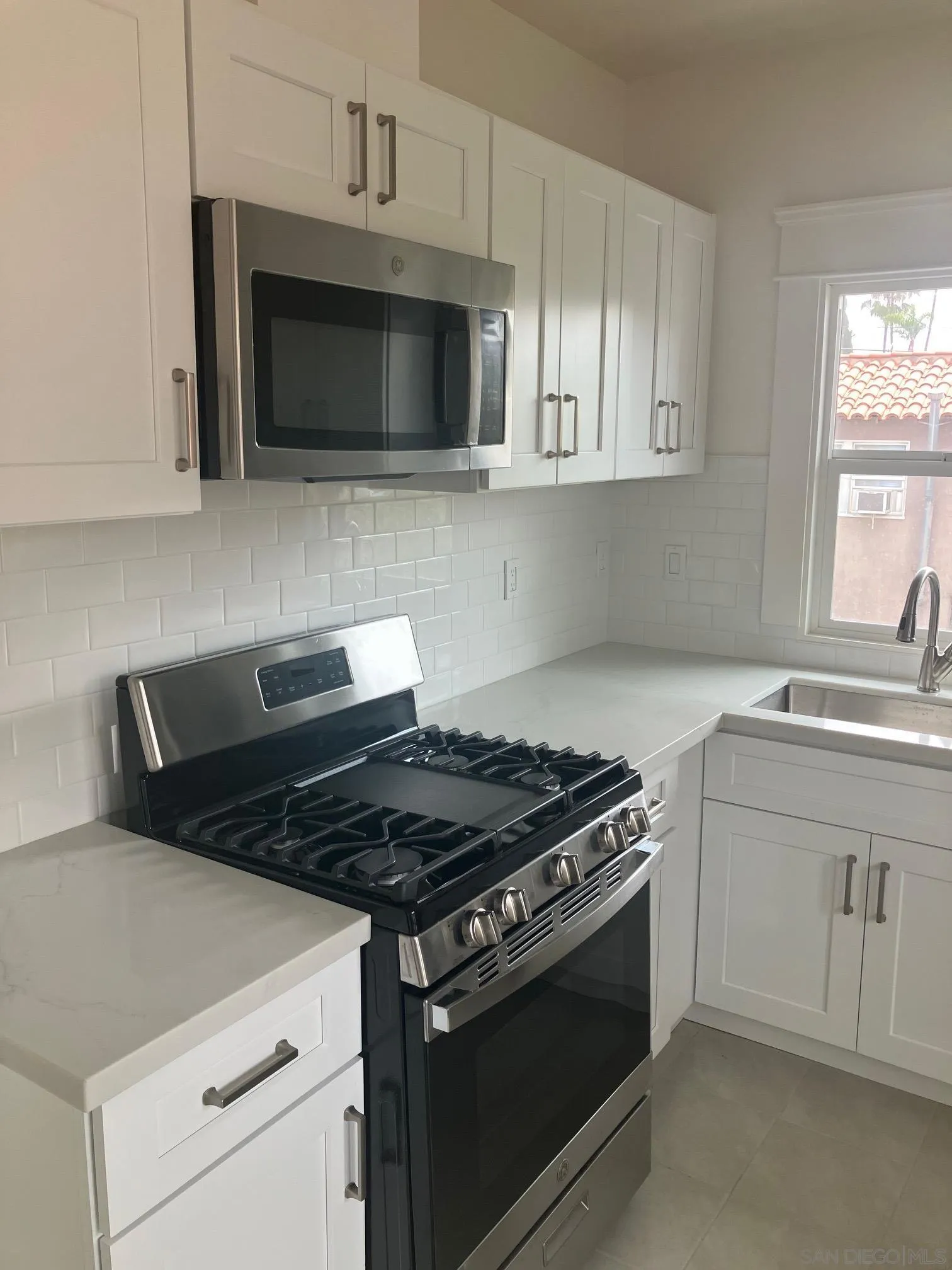 3965 Normal Street San Diego, CA 92103 - Photo 2 of 4 a kitchen with microwave cabinets and stove top oven