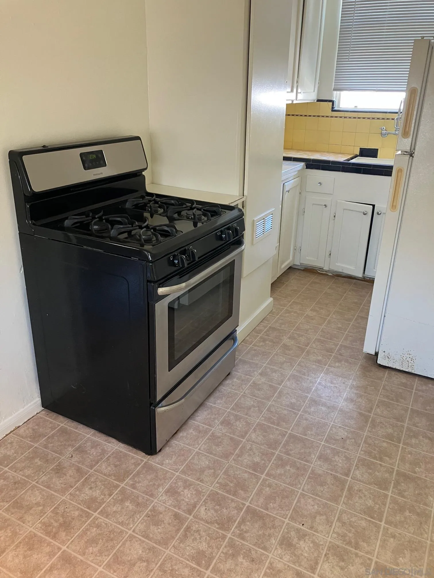 3965 Normal Street San Diego, CA 92103 - Photo 4 of 6 a kitchen with granite countertop a stove and a cabinets