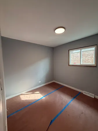 an empty room with a empty space and windows
