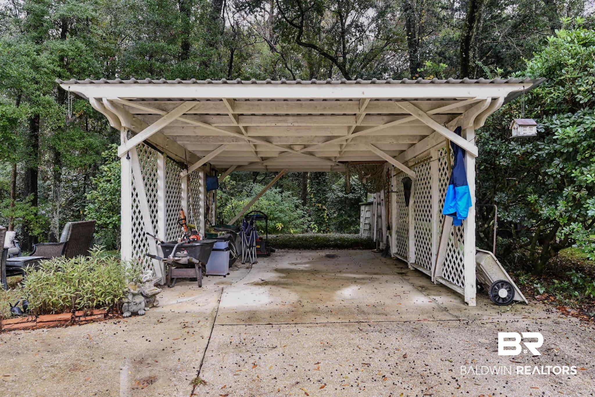 90 Paddock Drive Fairhope, AL 36532 - Photo 23 of 23 View of parking featuring a carport