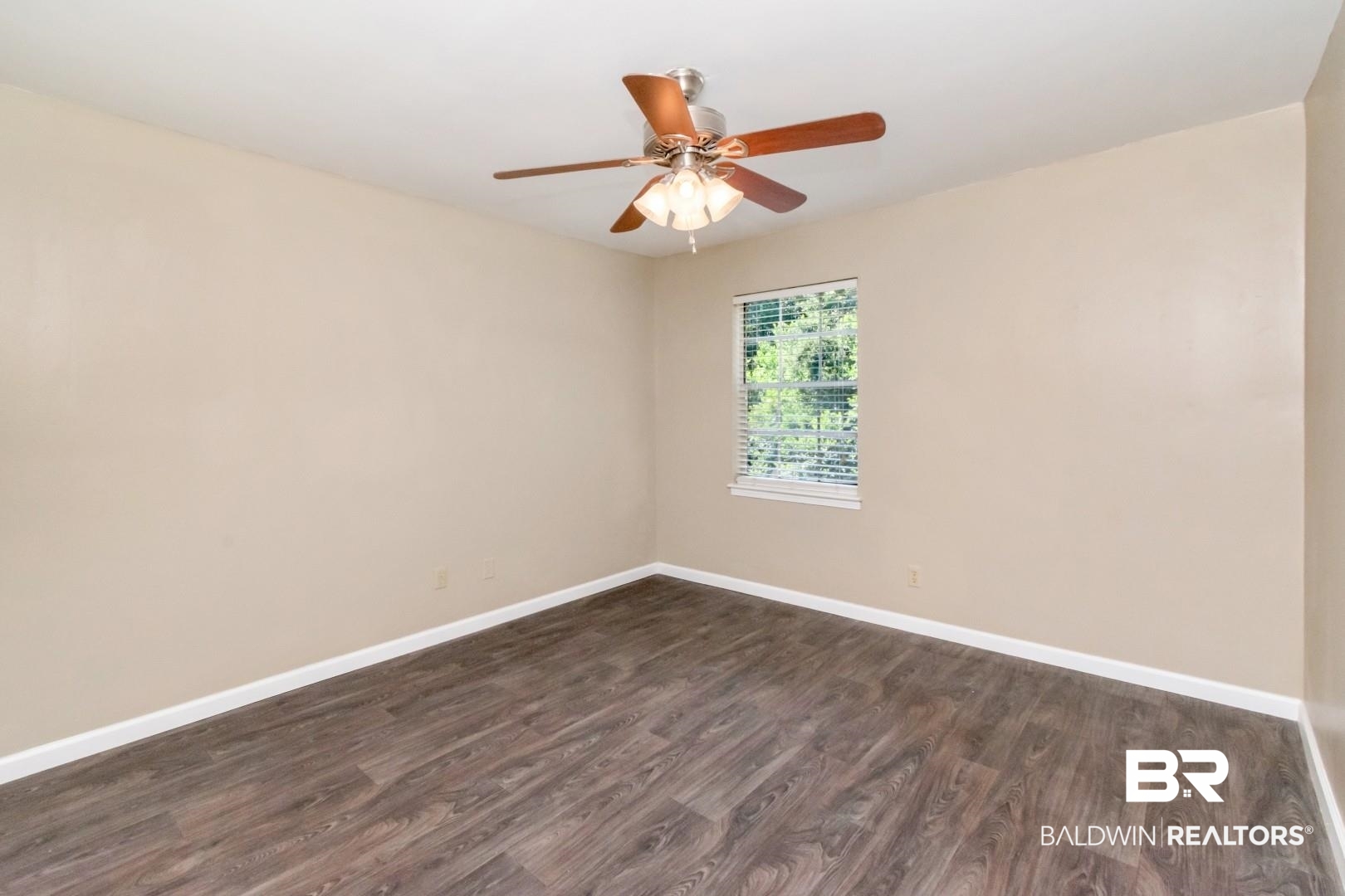 110 Du Rhu Drive, Unit E Mobile, AL 36608 - Photo 16 of 19 Spare room featuring dark wood-style floors and ceiling fan