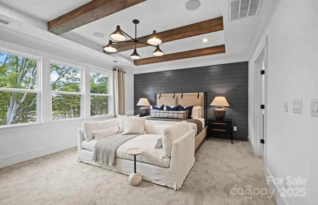 a bed room with furniture and a large window