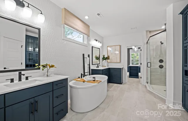 a large bathroom with a double vanity sink a mirror and shower