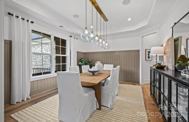a dining room with furniture window and wooden floor