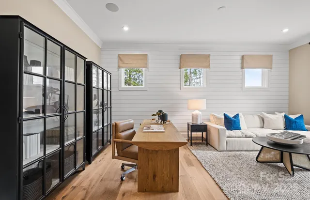 a living room with furniture wooden floor and a table