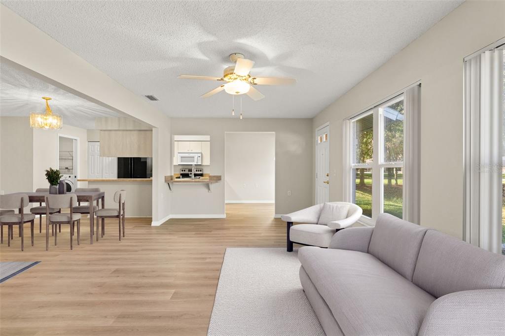 1415 Pinewood Hills Court Spring Hill, FL 34606 - Photo 11 of 45 a living room with furniture dining area and a flat screen tv