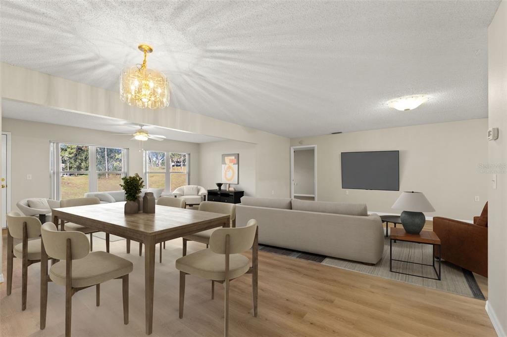 1415 Pinewood Hills Court Spring Hill, FL 34606 - Photo 13 of 45 a view of a dining room with furniture and a chandelier