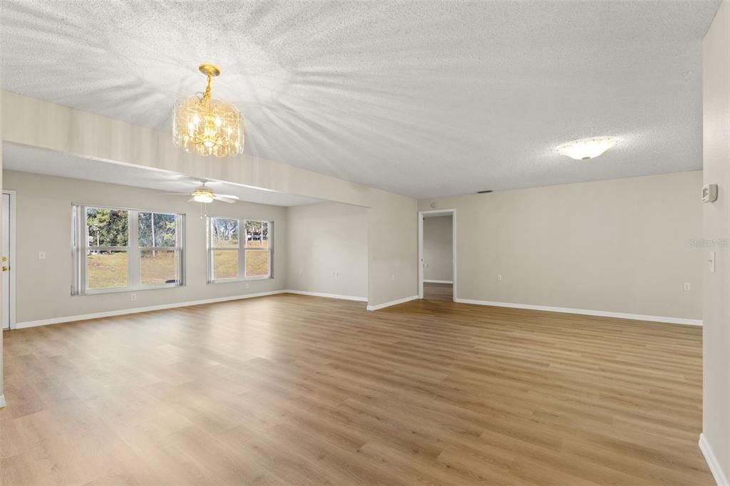 1415 Pinewood Hills Court Spring Hill, FL 34606 - Photo 14 of 45 wooden floor in an empty room with a window