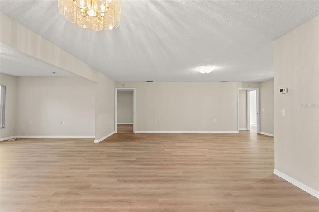 1415 Pinewood Hills Court Spring Hill, FL 34606 - Photo 15 of 45 a view of an empty room with wooden floor and a window