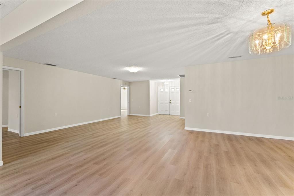 1415 Pinewood Hills Court Spring Hill, FL 34606 - Photo 16 of 45 a view of an empty room with wooden floor and a window
